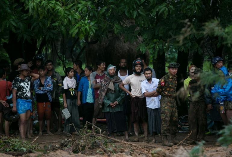  People wait to locate relatives still missing after a landslide in Paung township, Mon state on August 10, 2019. (Sai Aung Main / AFP)