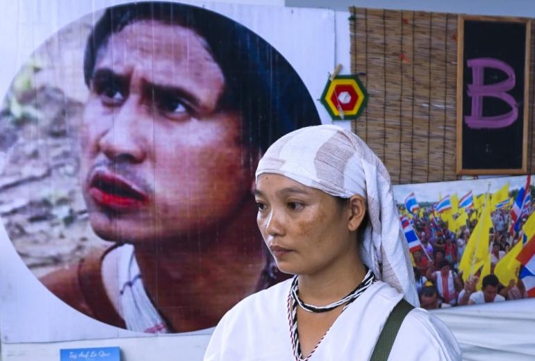  Pinnapha Phrueksapan, widow of ethnic Karen leader Por Cha Lee Rakcharoen—known as Billy, stands beside the portrait of her late husband following a ceremony in Bangkok on September 16, 2019. (Joe Freeman / AFP)