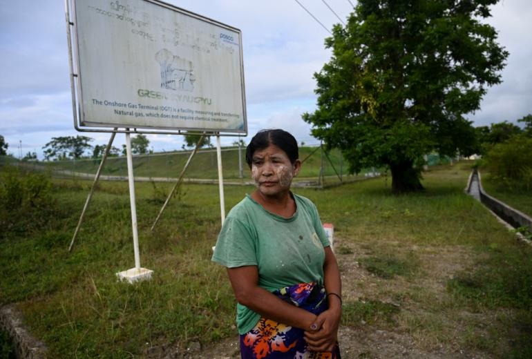 This photo taken on October 1, 2019 shows Myanmar resident Nu Aye Thar, standing outside the Posco International, formerly Posco Daewoo corporation, a South Korean onshore gas terminal facility in Kyaukphyu, Rakhine State. (Ye Aung Thu / AFP)