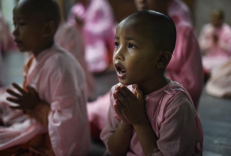 Buddhist nuns pray in the Mingalar Thaikti nunnery in Yangon. (Ye Aung Thu / AFP)