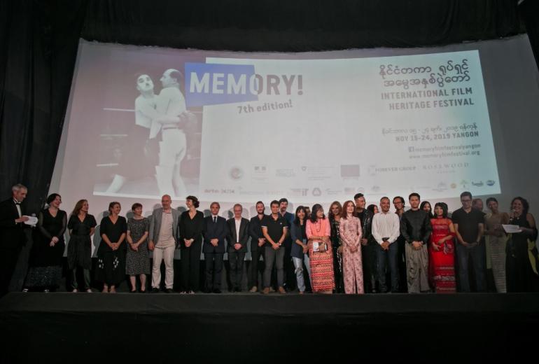 French actress Isabelle Huppert (front in pink dress) stands on stage during the opening ceremony of the Memory! International Film Heritage Festival, in Yangon on November 15, 2019. (Sai Aung Main / AFP)