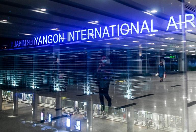  People wear facemasks amid concerns of the spread of the COVID-19 coronavirus while walking at Yangon international airport in Yangon on March 18, 2020. (Ye Aung Thu / AFP)