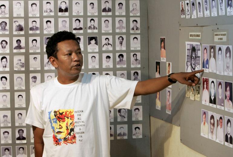 In this file photo taken on September 26, 2007, former political prisoner Bo Kyi talks about photos of other prisoners from the 1988 Myanmar uprising at a small museum in Mae Sot, near the Thai-Myanmar border. (Pornchai Kittiwongsakul / AFP)