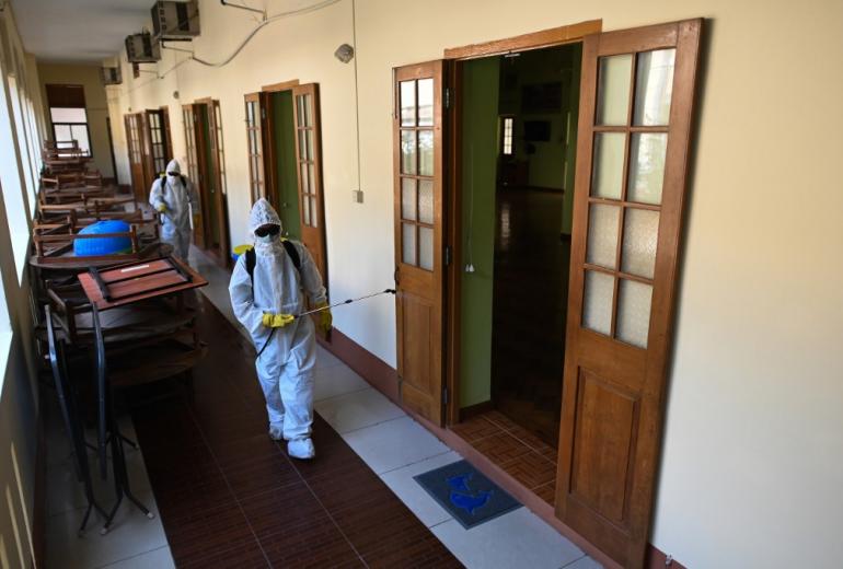 Myanmar military personnel wearing protective clothing disinfect a monastery as a preventive measure to contain the spread of COVID-19 coronavirus at Yangon on April 7, 2020. (Ye Aung Thu / AFP)