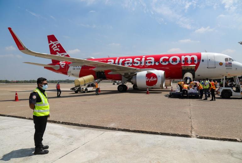 Airport staff unload boxes of COVID-19 coronavirus test kits donated by the European Union and Switzerland under the UN organised humanitarian flight on arrival at Yangon International Airport in Yangon on May 10, 2020.(Sai Aung Main / AFP)