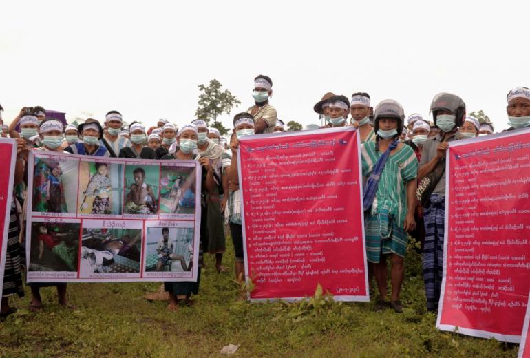 Karen ethnic people hold posters and shout slogans during a protest against Myanmar Army for the allegedly arbitrary killings, raping, shelling and for the removal of the army camps, at Hpapun in Kayin State on July 28, 2020. (STR / AFP)