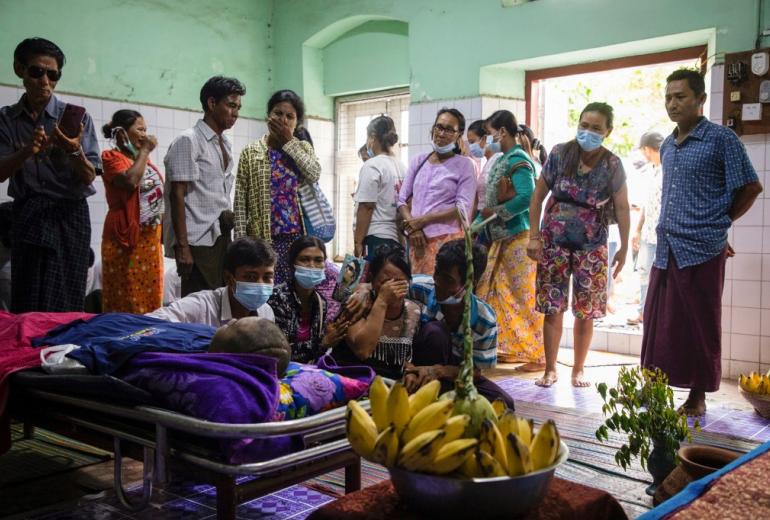 Relatives and family members look at the body of Khaing Zaw Tun, who had been held at a juvenile centre, at the Mandalay general hospital. (AFP)