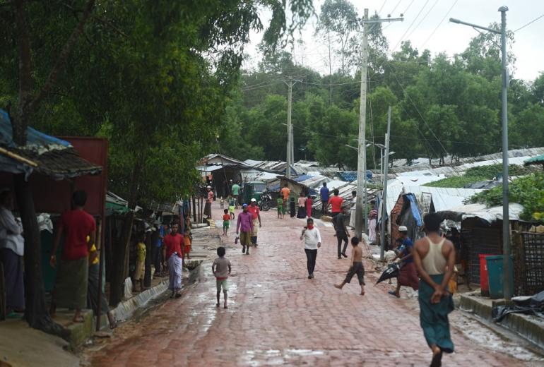 Rohingya refugees walk through the Kutupalong refugee camp near Ukhia on August 25, 2020. (Munir Uz zaman / AFP)