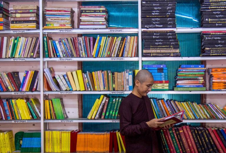 Myanmar Buddhist nun Ketumala reads a book in the library of a monastery in Yangon. (Sai Aung Main / AFP)