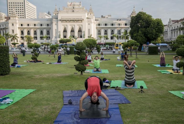 People practice yoga in Maha Bandula Park in downtown Yangon on December 4, 2020. (Sai Aung Main / AFP)