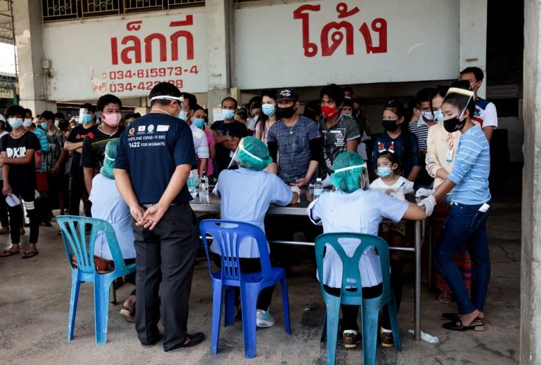 People queue to get tested for the Covid-19 at a seafood market in Samut Sakhon on December 19, 2020 after some cases of local infections were detected and linked to a vendor at the market. (Jack Taylor / AFP)