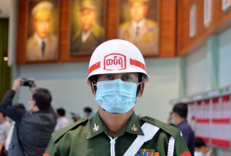 A military officer stands guard during a press briefing at the Defence Service Museum in Naypyidaw on January 26, 2021. (Thet Aung / AFP)