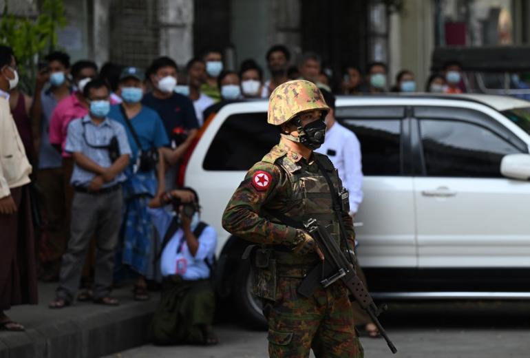 A soldier stands guard as troops arrive at a Hindu temple in Yangon on February 2, 2021, as Myanmar's generals appeared in firm control a day after a surgical coup that saw democracy heroine Suu Kyi detained. (STR / AFP)