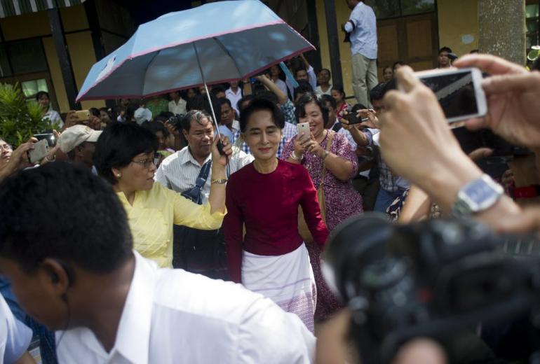 In this file photo taken on November 8, 2015, Myanmar opposition leader and head of the National League for Democracy (NLD) Aung San Suu Kyi (C) visits a polling station in Kawhmu township, Yangon. (AFP)