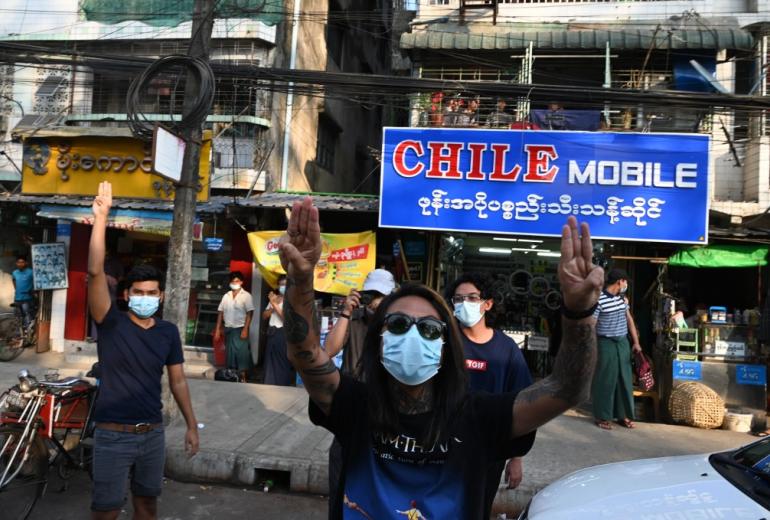 People give hold up three-finger salutes, after calls for protest against the military coup emerged on social media, in Yangon on February 4, 2021. (STR / AFP)