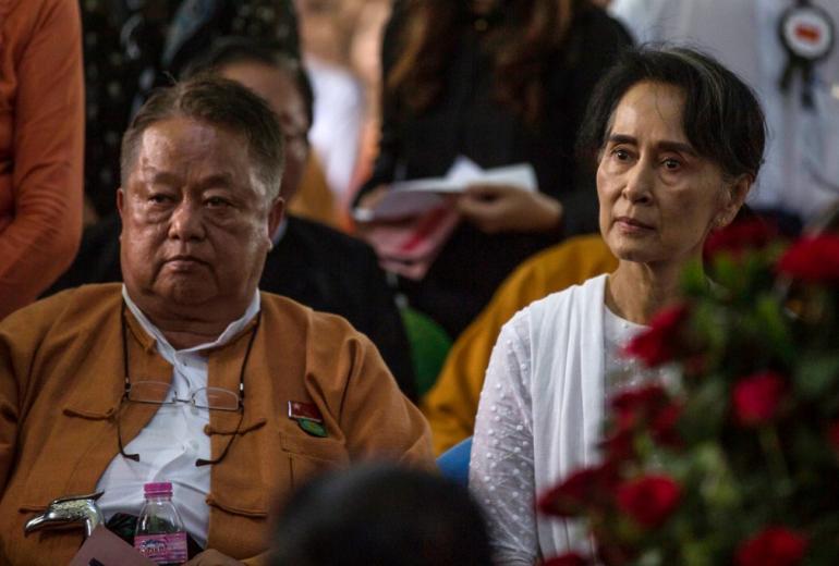 This file photo taken on August 17, 2017 shows Win Htein (L), chief executive committee member of the National League for Democracy (NLD) and a key aide to Myanmar's State Counselor Aung San Suu Kyi (R), attending the funeral service of the NLD party's former chairman Aung Shwe in Yangon. A key aide of Myanmar's ousted leader Aung San Suu Kyi was arrested in the early hours of February 5, 2021, a press officer from her National League for Democracy (NLD) party said. (STR)        
