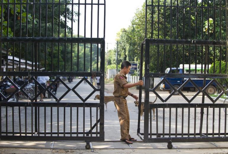 A guard closes a gate leading to Myanmar's Insein prison. (Ye Aung Thu / AFP)