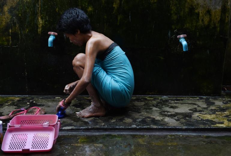 A 26-year old sex worker positive with HIV takes a bath at a treatment centre on the outskirts of Yangon. (Romeo Gacad / AFP)