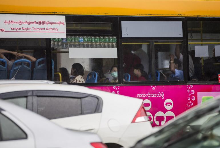 Commuters taking a bus in Yangon in July, 2017. (Aung Kyaw Htet / AFP)