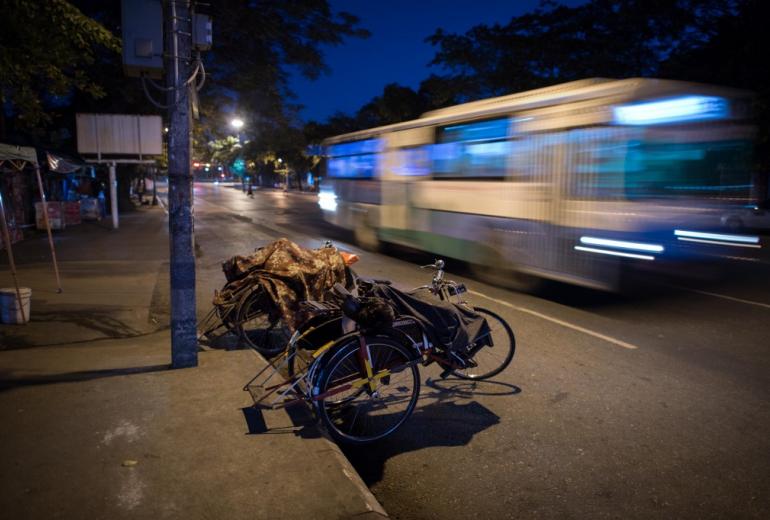An early morning bus rushes by in Yangon. (Roberto Schmidt / AFP)
