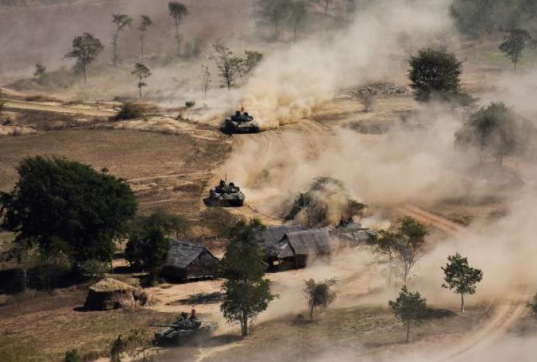 In this file photo taken on 21 January 2019 Myanmar military tanks manoeuvre in a field during combined exercise by Myanmar army and air force near Magway. (AFP)