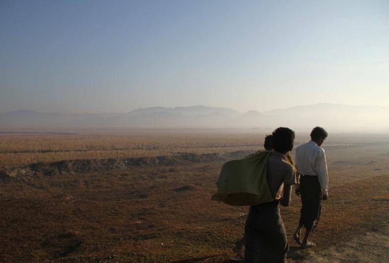  Three people walking along a road are seen during a government-organized visit for journalists in Buthidaung townships close to the surge of fighting between the Arakan Army and government troops in Rakhine state on January 25, 2019. (Richard Sargent / AFP)