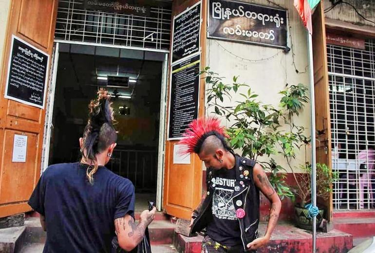 Kyaw Gyi (left) and Kyaw Kyaw leave their cell after being arrested at a Yangon festival. (Facebook)