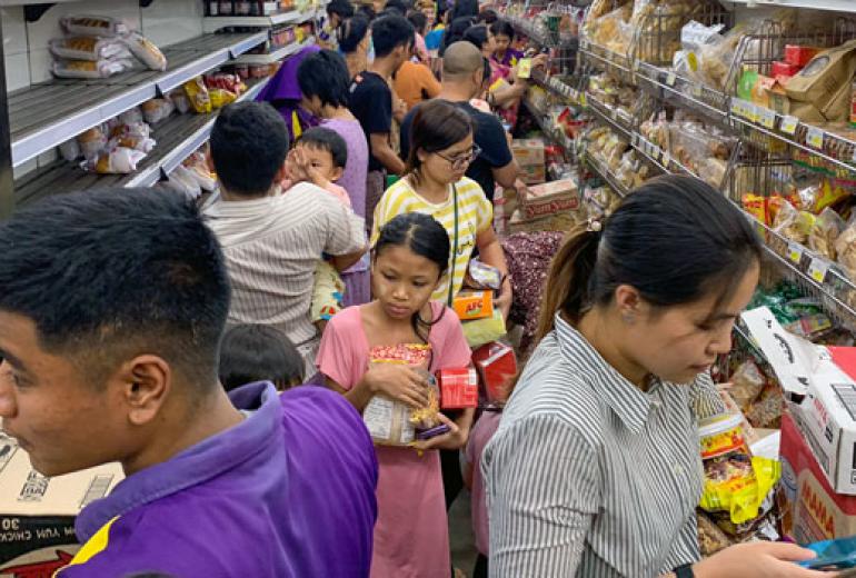 Shoppers stock up on supplies at City Mart after hearing rumours related to the coronavirus outbreak. (AFP)