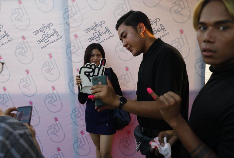 People post for photos at Yangon Pride boat parade on January 18. (Thet Htoo / Mg Nyan)