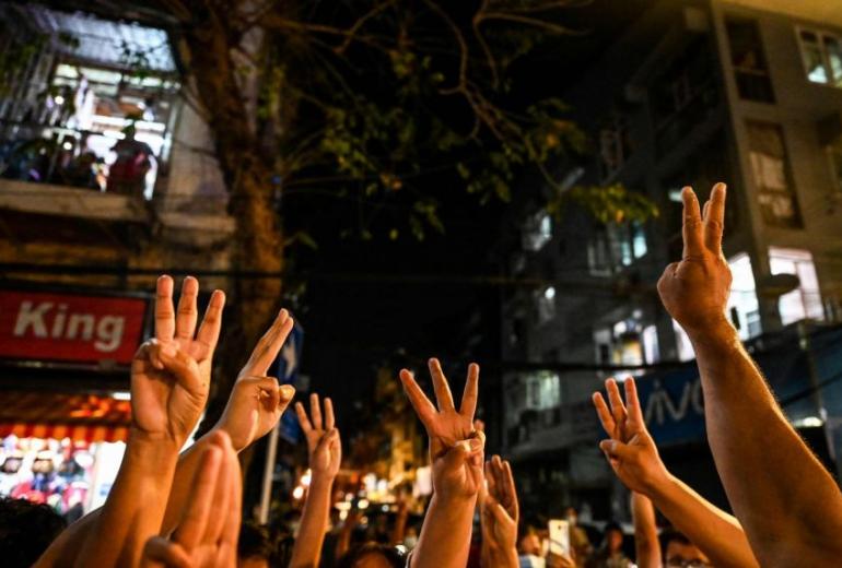 People give a three-finger salute after calls for protest went out on social media in Yangon on Feb 3, 2021 following the coup. (AFP)