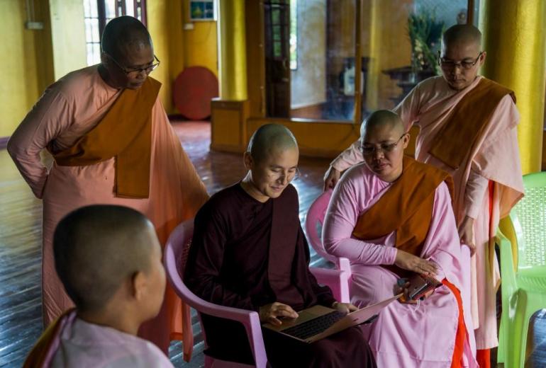 A Buddhist nun shows others how to use a laptop for a Zoom group meeting at a monastery in Yangon. (Sai Aung Main / AFP)
