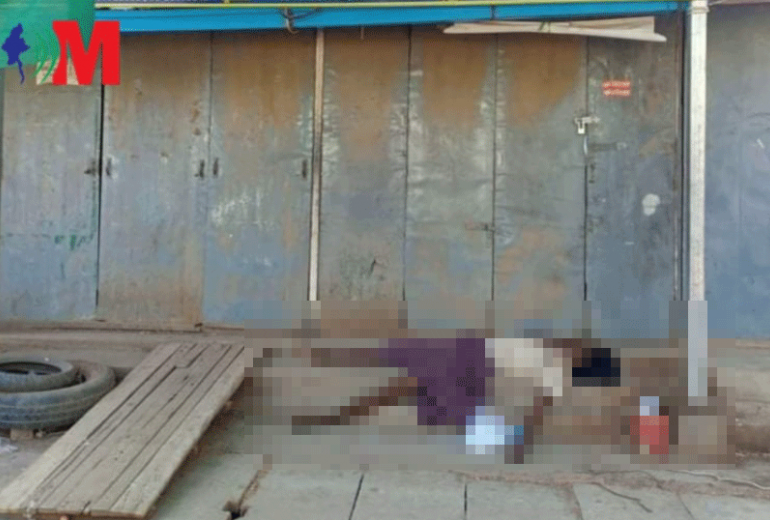 In this photograph published by Voice of Myanmar, the atrophied limbs of a dead man hang over steps at a bus terminal in central Myanmar. A waste collector, police say he died of malnutrition after recycling shops closed due to Covid-19. 