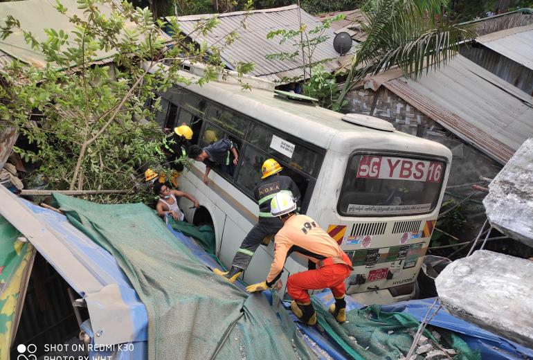 Myanmar Fire Services Department posted this photo on Facebook of the Yangon Bus Service vehicle lodged into the homes.