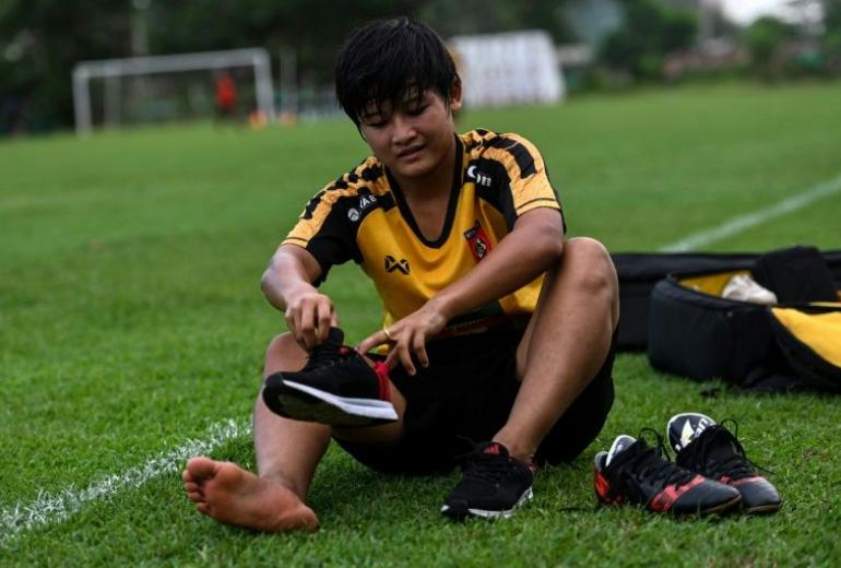 San Thaw Thaw fled from her family's paddy fields to follow her footballing dreams, inspired by her girlhood hero Wayne Rooney. (Ye Aung Thu / AFP)