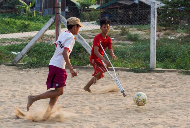 Kaung Khant Lin (right) playing football with his friends in Yangon. (Sai Aung Main / AFP)