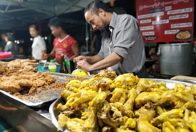 Hashim Bai serves customers at the popular street food stall in downtown Yangon. (Myanmar Mix)