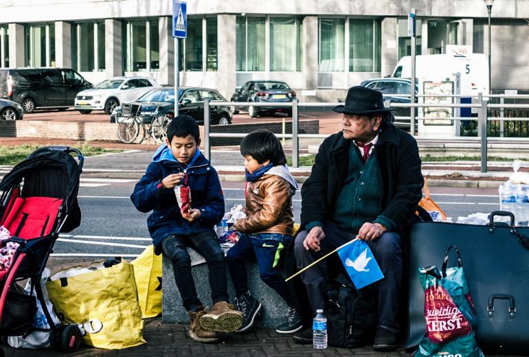 An Aung San Suu Kyi supporter with his family in The Hague, to support Myanmar's civilian leader in the Rohingya genocide case. (Min Sett Hein)