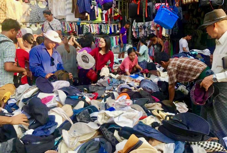 Shoppers crowd at a stall on the Zay Gyi Street market. (Rita Shan)