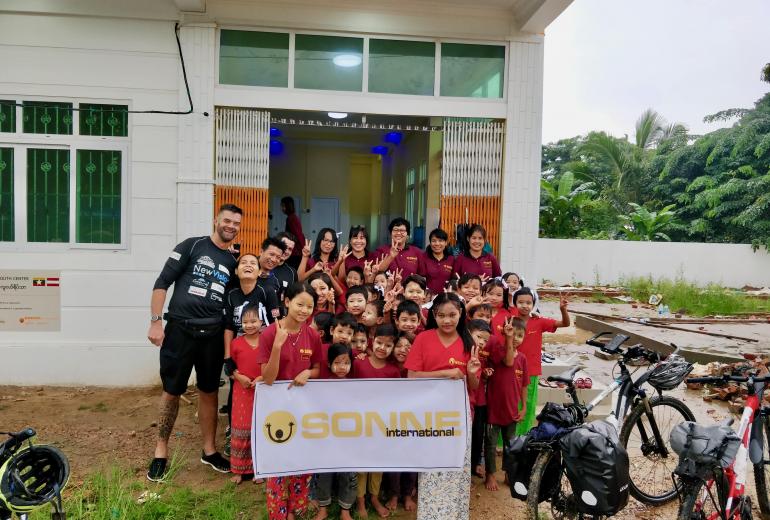 The adventurers begin their cycle to Singapore from the new SONNE International children's centre in Yangon. (Myanmar Mix)