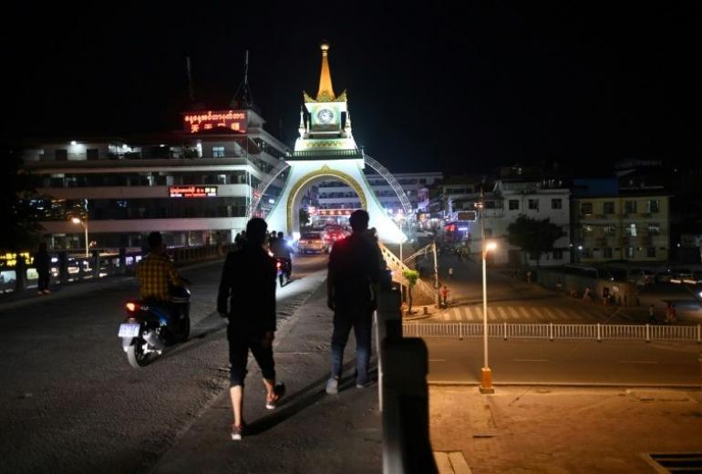 People walk on the street in Mongla, Special Region Four, in eastern Shan State. (Ye Aung Thu / AFP)