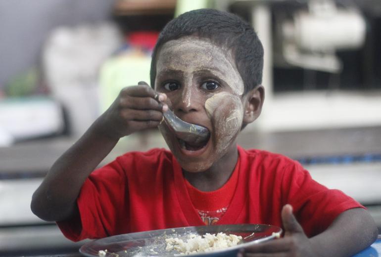 A boy eats lunch at a SONNE Social Organisation centre in Yangon. (Myanmar Mix)