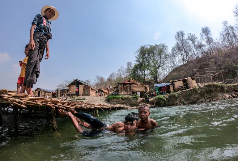 For more than a mile, small huts line the river, partitioned off by bamboo bridges creating numerous self-contained swimming areas. (Dominic Horner)