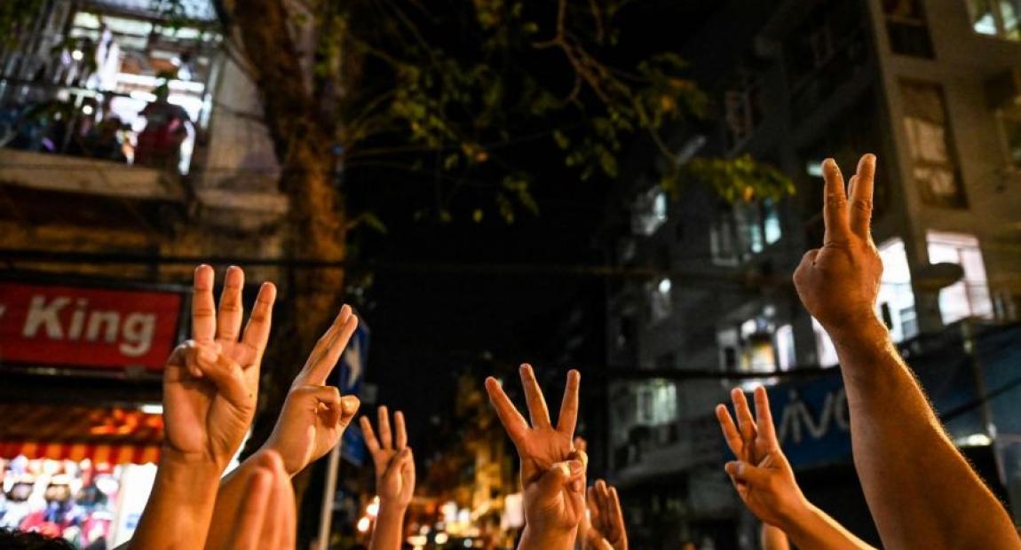 People give a three-finger salute after calls for protest went out on social media in Yangon on Feb 3, 2021 following the coup. (AFP)
