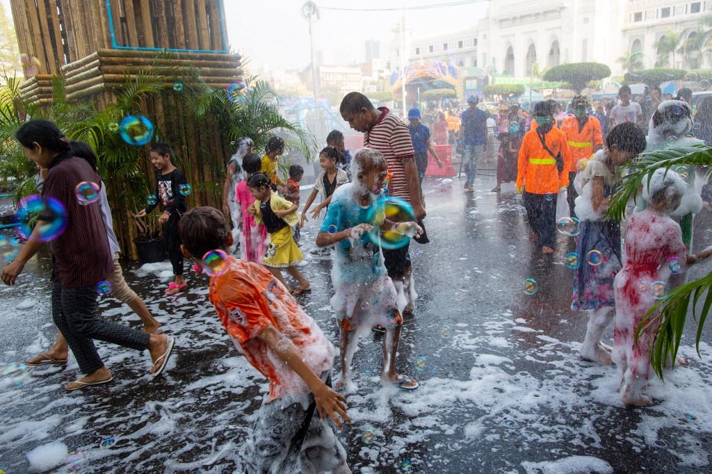 Children play with water during celebrations in downtown Yangon. (Sai Aung / AFP)