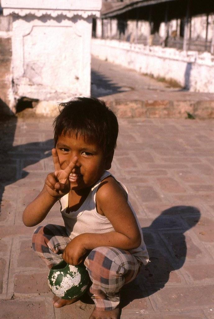 A boy flicks the peace sign in Mandalay.