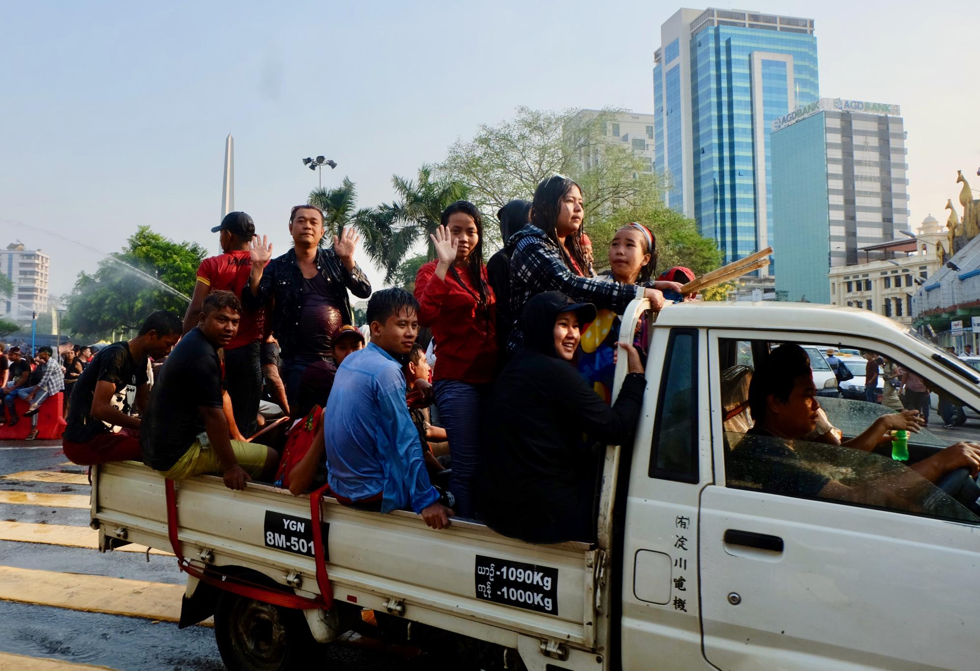 Revellers drive past Sule Pagoda during Thingyan celebrations. (Myanmar Mix)