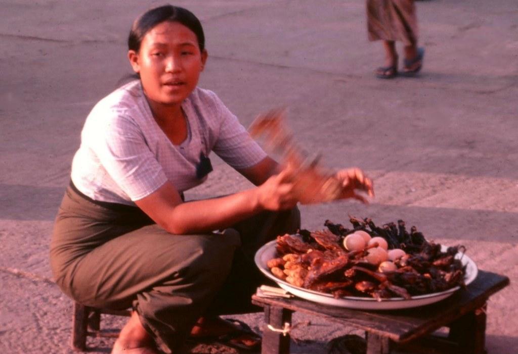 A vendor sells fried meat and eggs.