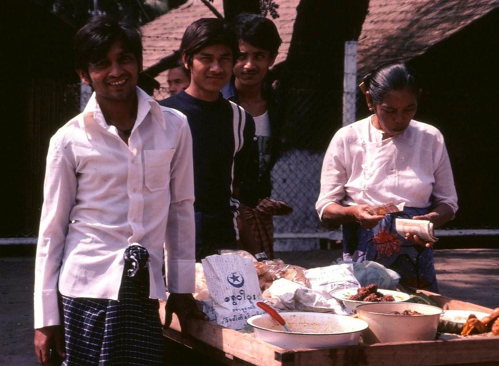 Food vendors smile at the camera.