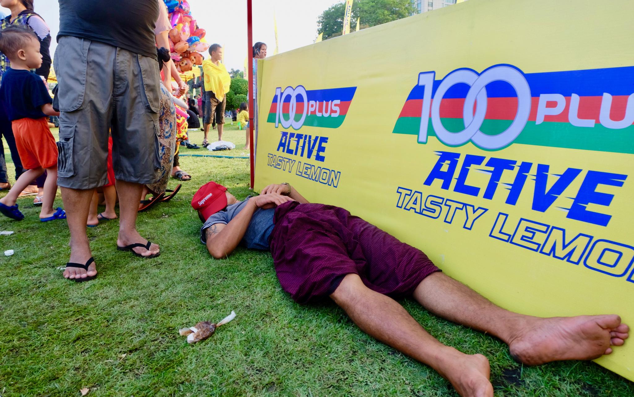 A man takes a rest from the Thingyan party at Maha Bandula Park. (Myanmar Mix)