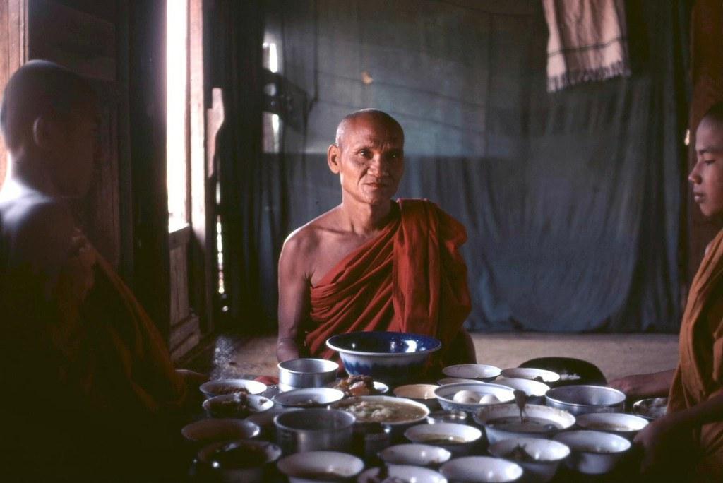 Monks sit down for a meal at their monastery in Bagan after collecting alms.